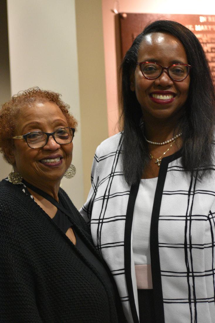 Two branch members posing together at a community event