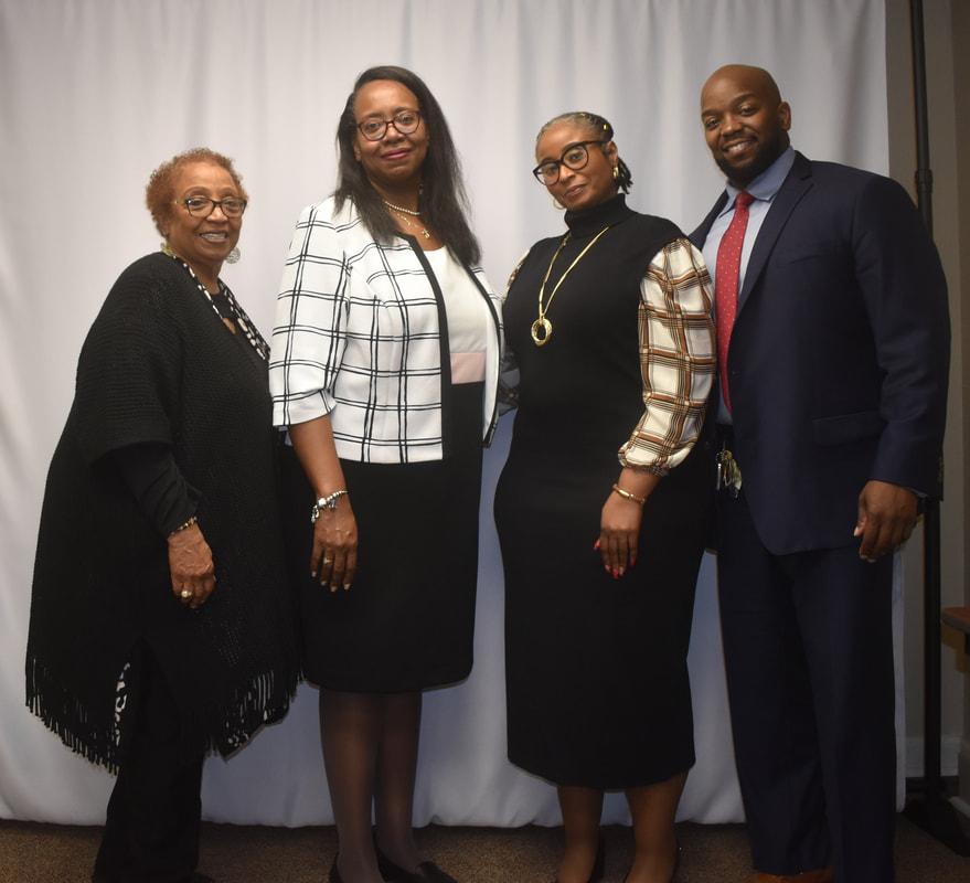 Group of four branch leaders posing together at a formal event
